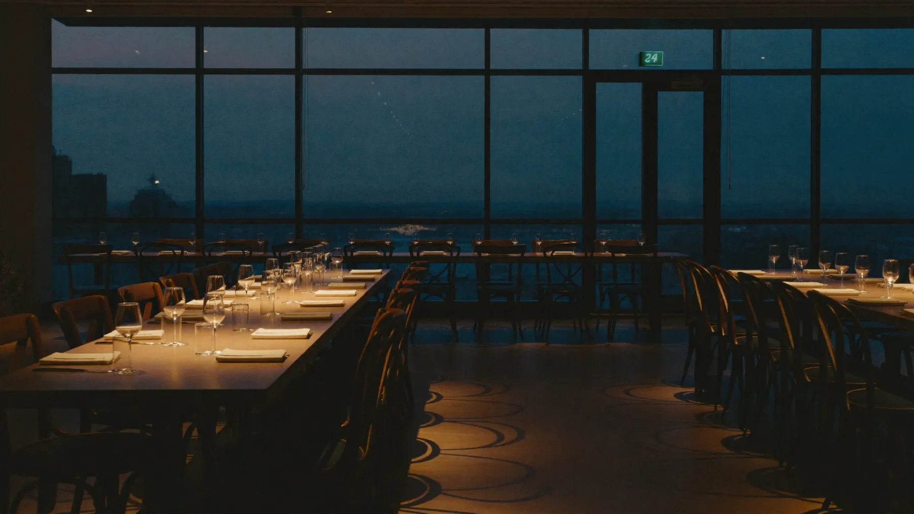 A long table laid out in an empty venue before an evening event